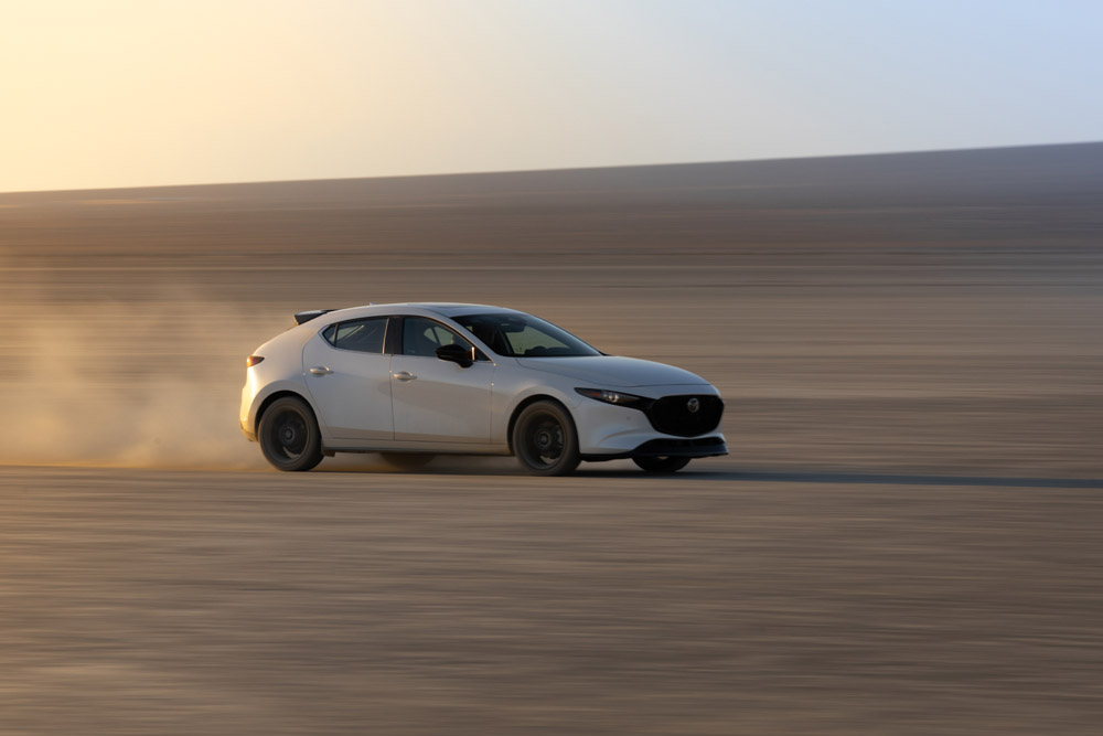2025 Mazda Mazda3 Turbo AWD Premium Plus driving on El Mirage Dry Lake Bed