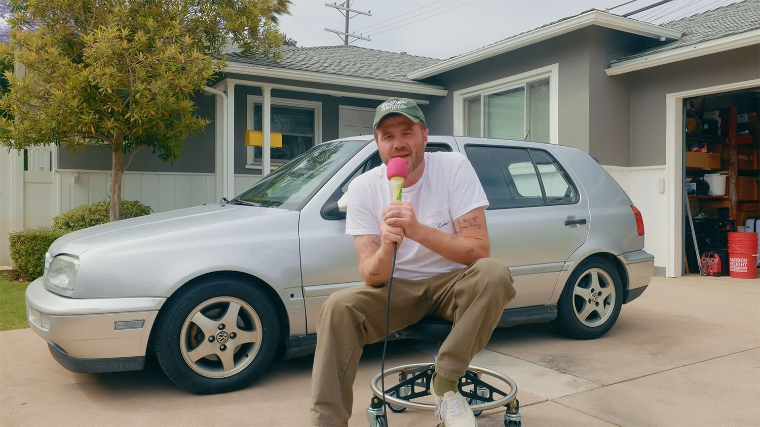 James Pumphrey sitting in front of his MK3 Volkswagen Golf Budget Project