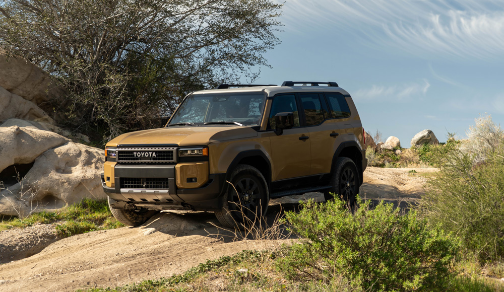 Off-Roading a 2026 Toyota Land Cruiser at Cleghorn OHV near San Bernardino in Southern California posed coming down a steep rock